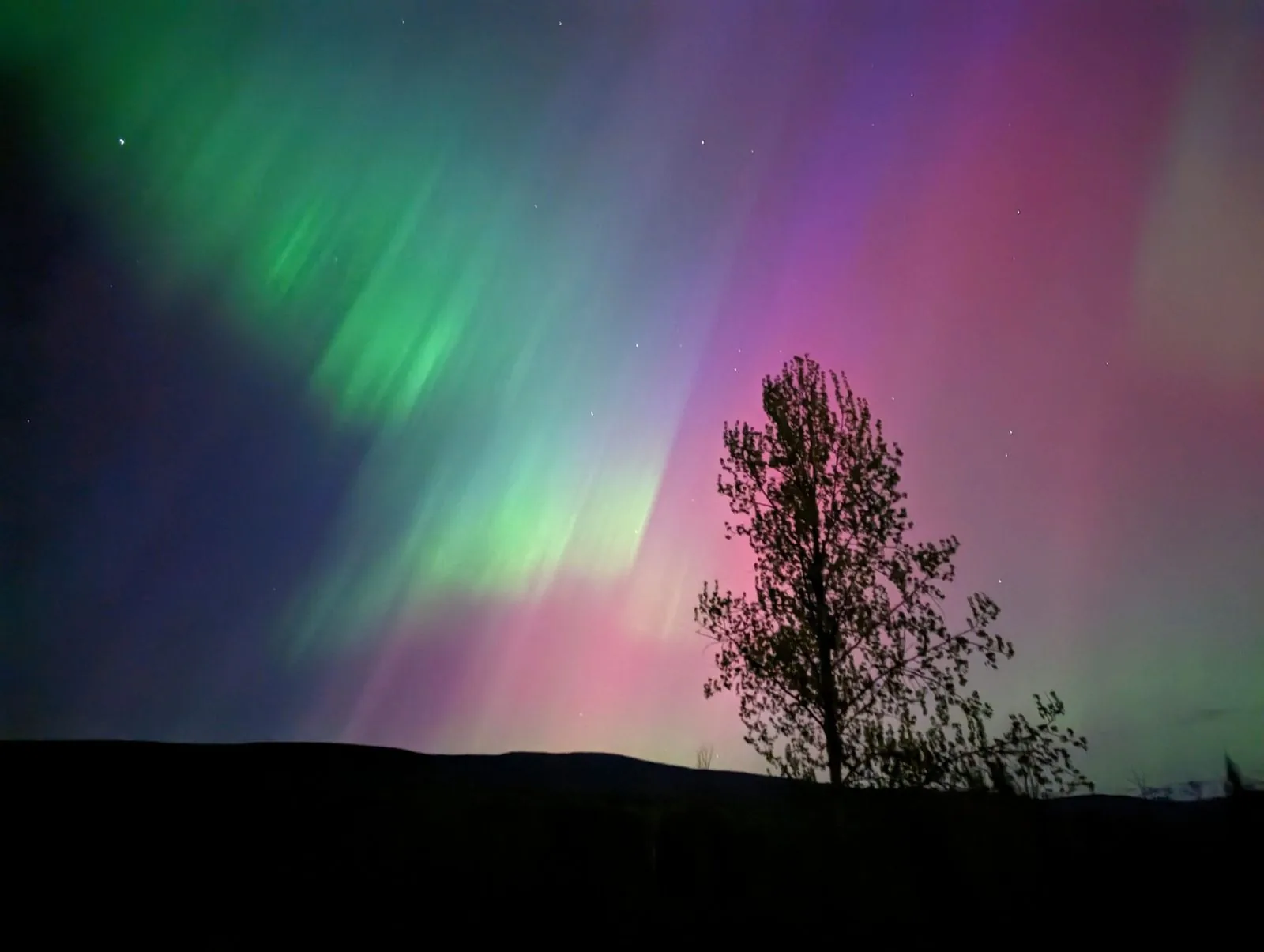 aurora over the land at night